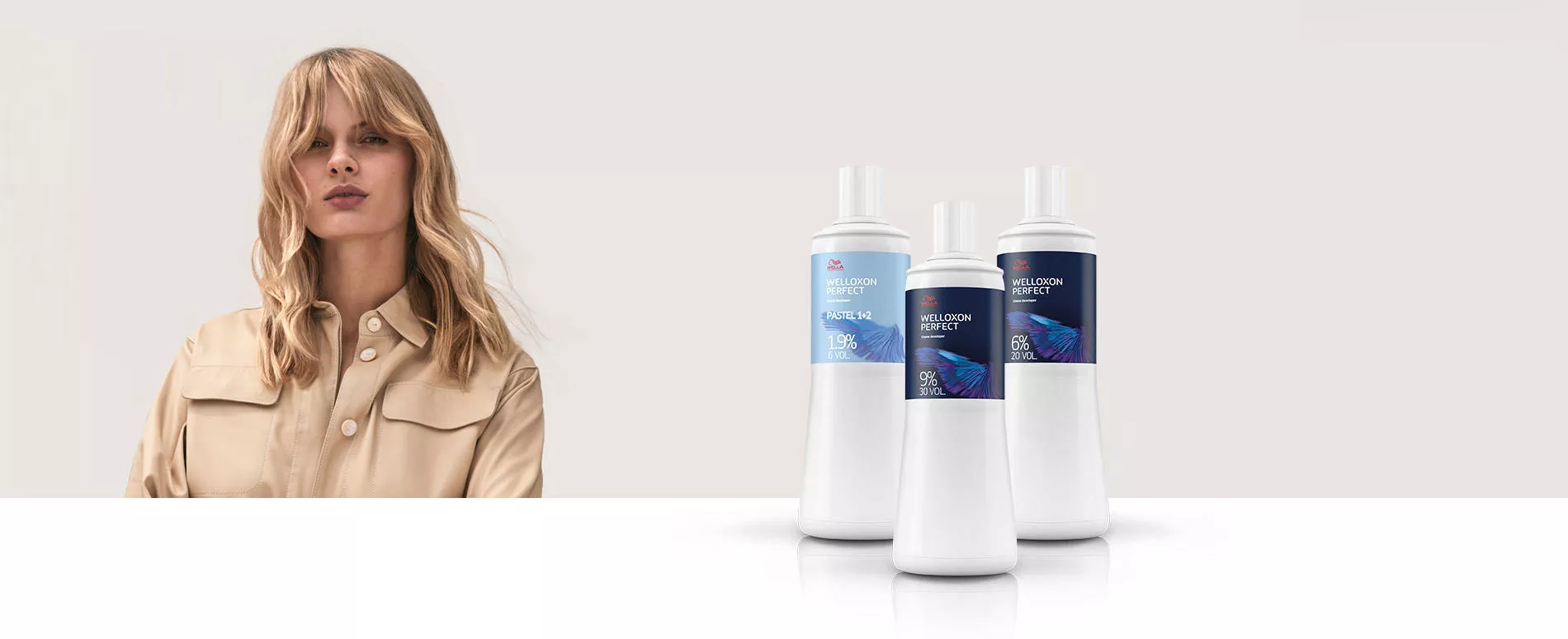 A woman with long, very dark, straight hair looking back over her shoulder, and 3 white bottles of Welloxon Perfect