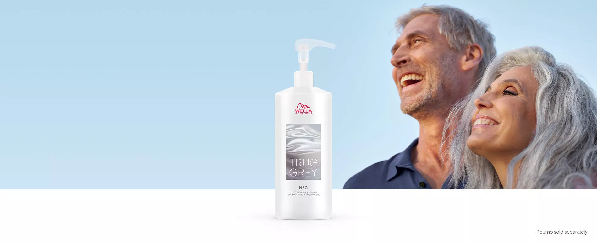 Male and female with natural grey hair laughing in the sun with True Grey conditioning perfector bottle in the foreground