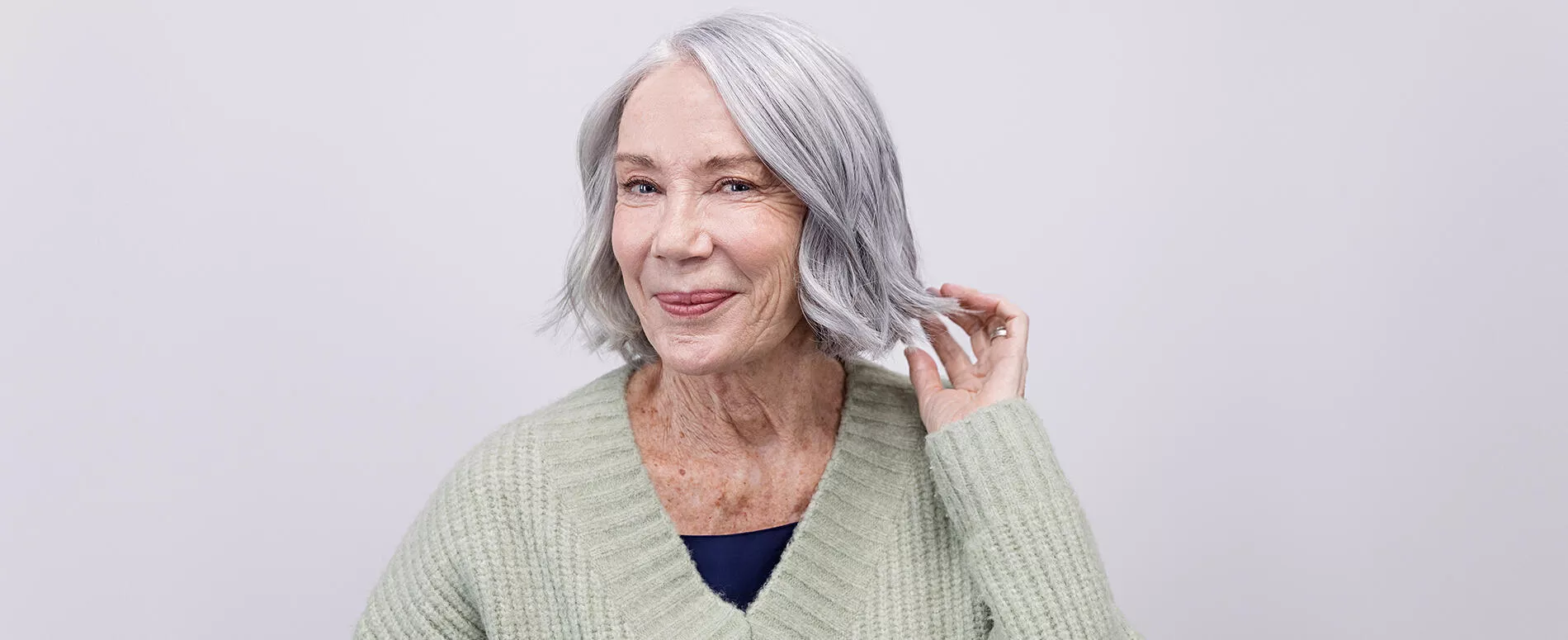 Image of female with short silver glossy hair color